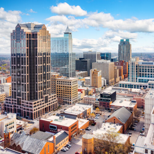 Aerial view of Raleigh, North Carolina skyline on a sunny day.
